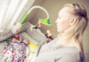 Mom Looks At Her Son In Bed